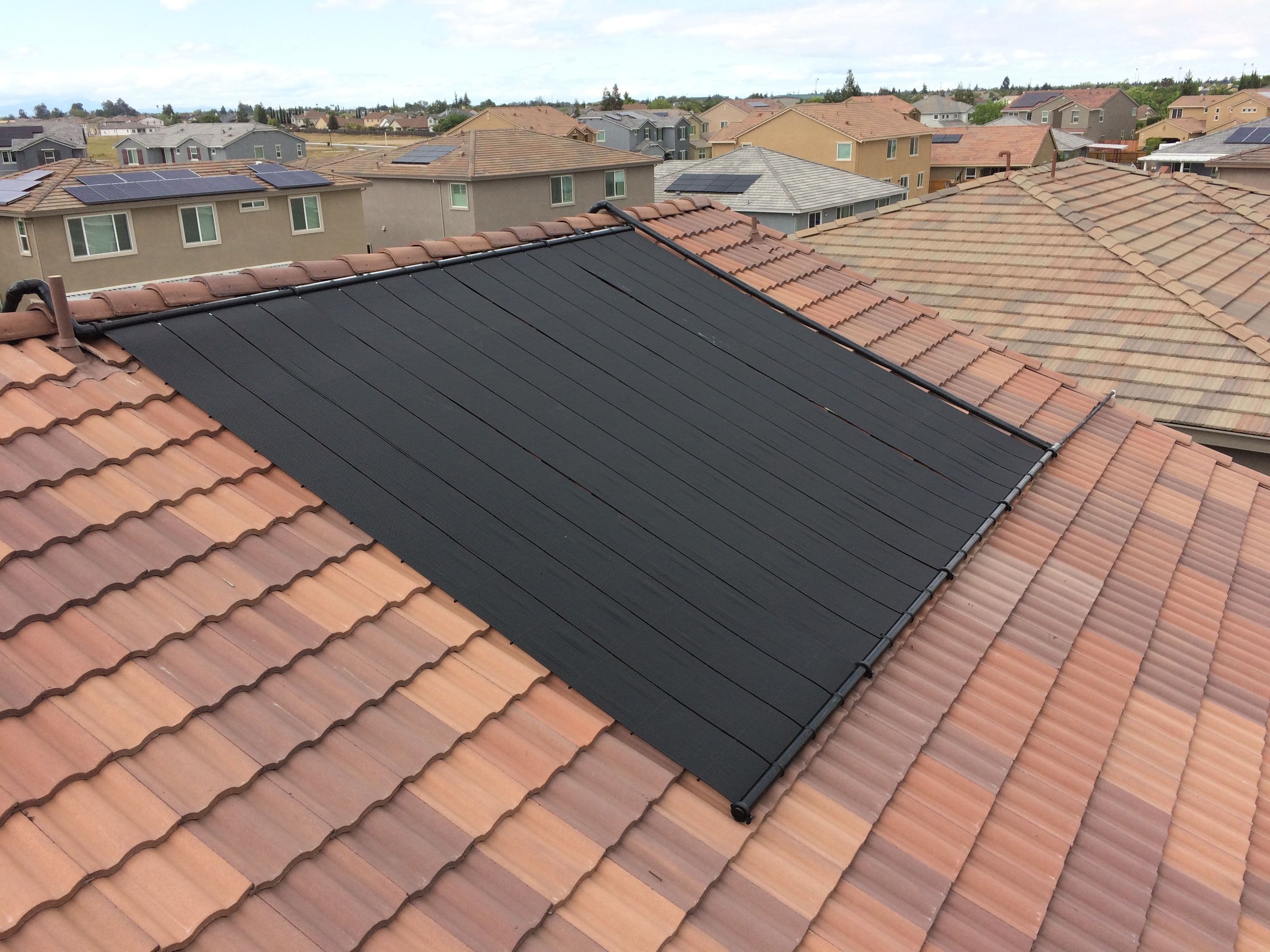 Heliocol solar pool heating collectors installed on a residential rooftop